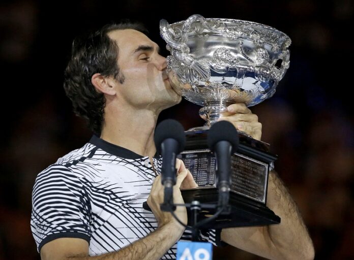 Switzerland's Roger Federer kisses his trophy after defeating Spain's Rafael Nadal during the men's singles final at the Australian Open tennis championships Sunday in Melbourne, Australia. Photo: Aaron Favila / Associated Press
