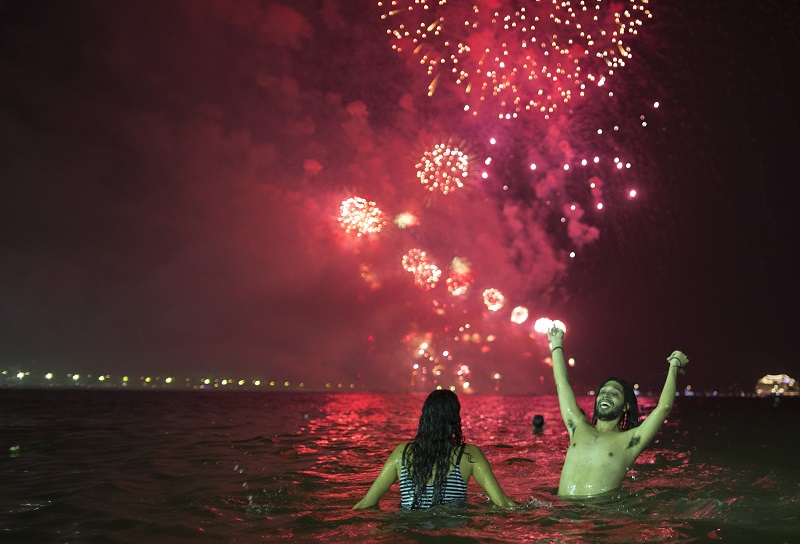 People watch the fireworks exploding over Copacabana beach during the New Year's Eve celebrations in Rio de Janeiro, Brazil, Sunday, Jan. 1, 2017. Photo: Leo Correa / Associated Press