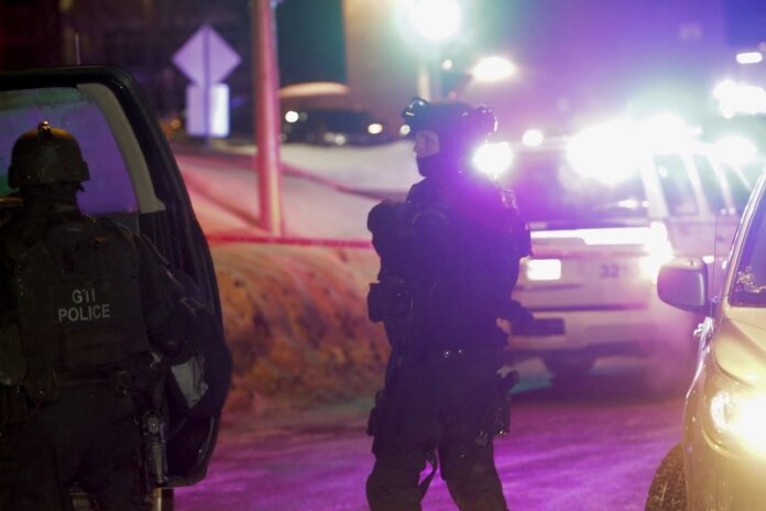 Police survey the scene after a deadly shooting at a mosque Sunday in Quebec City, Canada. Photo: Francis Vachon / Associated Press