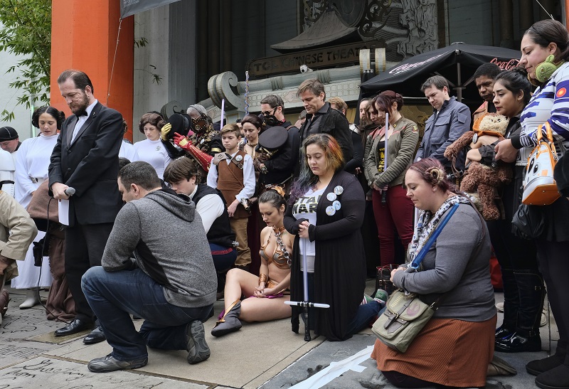 Costumed fans gather for a moment of silence for actress Carrie Fisher in the forecourt at the TCL Chinese Theatre in the Hollywood section of Los Angeles on Saturday. Photo: Richard Vogel / Associated Press