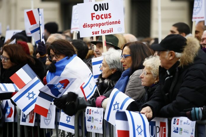 Pro-Israel demonstrators hold a placard reading