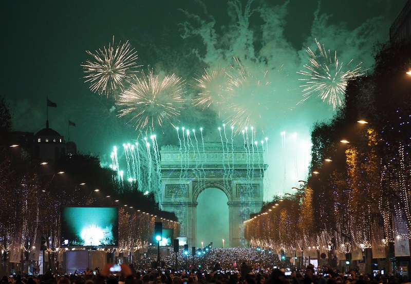 Revellers photograph fireworks over the Arc de Triomphe as they celebrate the New Year on the Champs Elysees, in Paris, France, Sunday, Jan.1, 2017. Photo: Christophe Ena / Associated Press