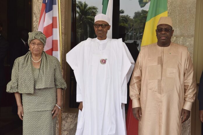 Liberia President, Ellen Johnson Sirleaf, left, Nigeria President Muhammadu Buhari, centre, and Senegal President Macky Sall, poses Monday for a photograph before a meeting in Abuja, Nigeria. Photo: Azeez Akunleyan / Associated Press