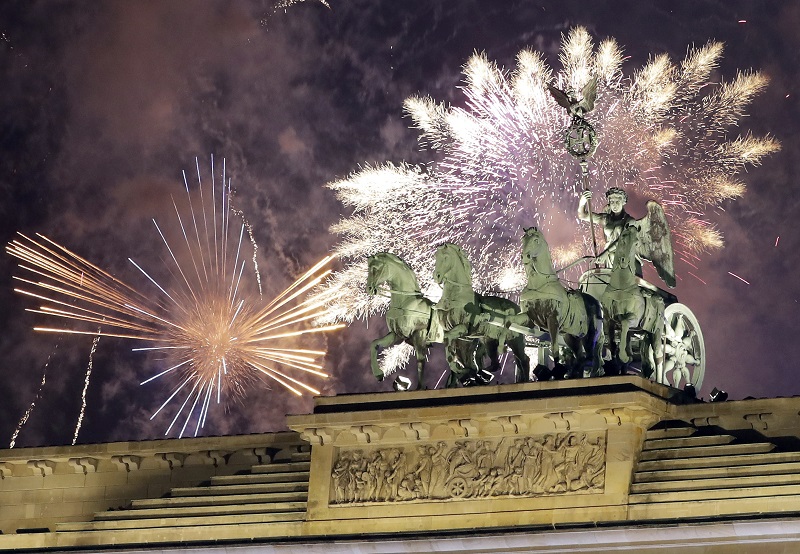 Fireworks light the sky above the Quadriga at the Brandenburg Gate shortly after midnight in Berlin, Germany, Sunday, Jan. 1, 2017. Hundred thousands of people celebrated New Year's Eve welcoming the new year 2017 in Germany's capital. Photo: Michael Sohn / Associated Press