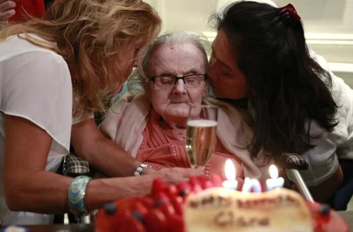 Clare Hollingworth, center, a British former longtime foreign correspondent, is surrounded in October by friends and admirers at her birthday party at Hong Kong's Foreign Correspondents' Club. Photo: Kin Cheung / Associated Press