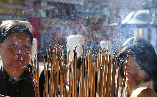 JAPAN: People offer prayers during celebrations of the Lunar New Year Saturday at Chinatown in Yokohama, near Tokyo. Photo: Koji Sasahara / Associated Press