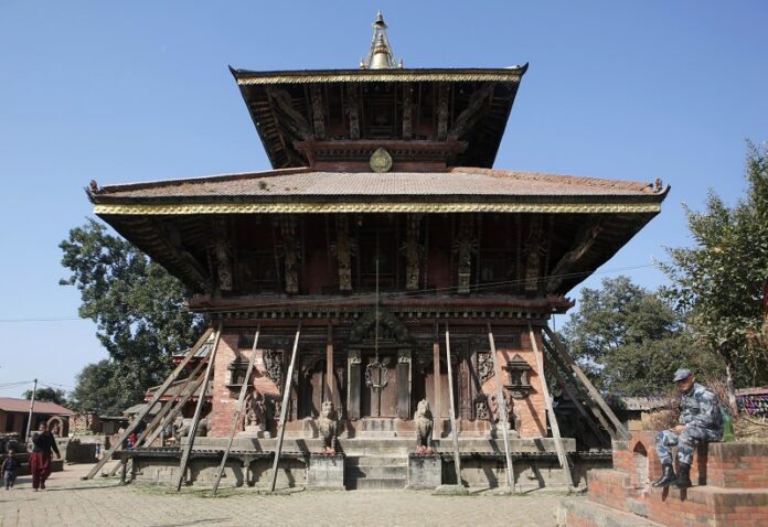 A Nepalese policeman rests last November in front of Changu Narayan, a temple dedicated to Lord Vishnu, at Changu Village, 20 kilometers (12.5 miles) east of Kathmandu, Nepal. Photo: Niranjan Shrestha / Associated Press