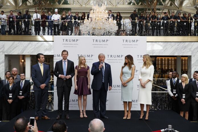 Republican President Elect Donald Trump, accompanied by, from left, Donald Trump Jr., Eric Trump, Trump, Melania Trump, Tiffany Trump and Ivanka Trump, speaks during the grand opening of the Trump International Hotel- Old Post Office, in October in Washington. Photo: Evan Vucci / Associated Press