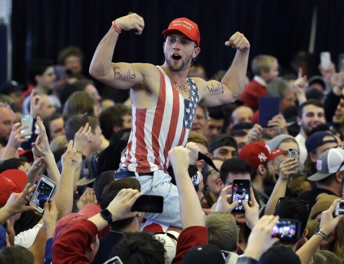 A Donald Trump supporter flexes his muscles in 2017 with the words A Donald Trump supporter flexes his muscles in 2017 with the words