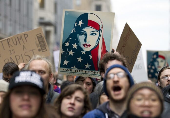 Demonstrators march on the street near a security checkpoint inaugural entrance, Friday in Washington, ahead of President-elect Donald Trump's inauguration. Photo: Jose Luis Magana / Associated Press