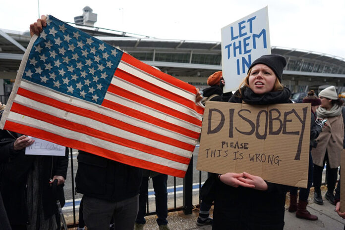 Protesters assemble at JFK International Airport in New York on Saturday after two Iraqi refugees were detained trying to enter the United States. Photo: Craig Ruttle / Associated Press