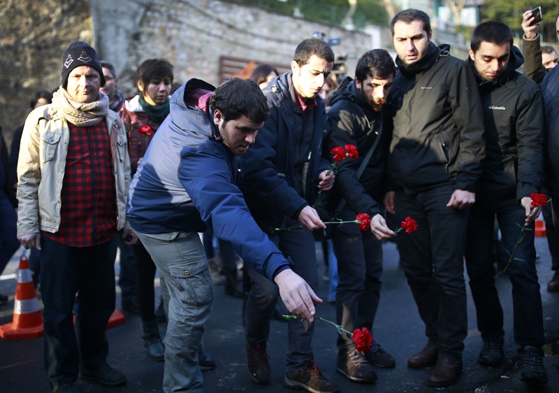 People leave flowers for the victims outside a nightclub which was attacked by a gunman overnight, in Istanbul, on Sunday. Photo: Emrah Gurel / Associated Press