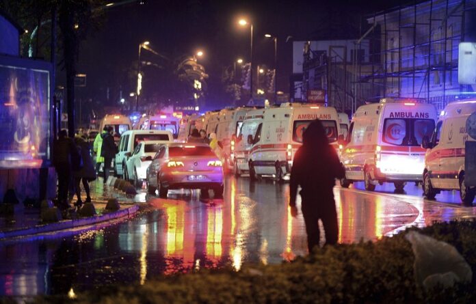 Medics and security officials work at the scene after an attack at a popular nightclub in Istanbul, early Sunday. Turkey's state-run news agency says an armed assailant has opened fire at a nightclub in Istanbul during New Year's celebrations, wounding several people. Photo: IHA via AP