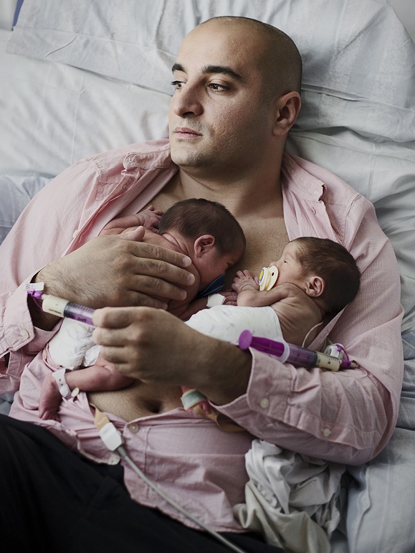 A Swedish father takes months of parental leave to care for his twins at home. Photo: Johan Bavman