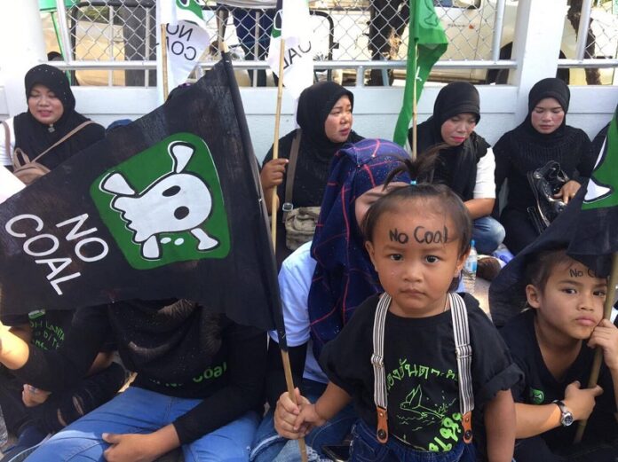 Opponents gather in front of the Government House on Friday morning to protest plans to build a coal-fired power plant.