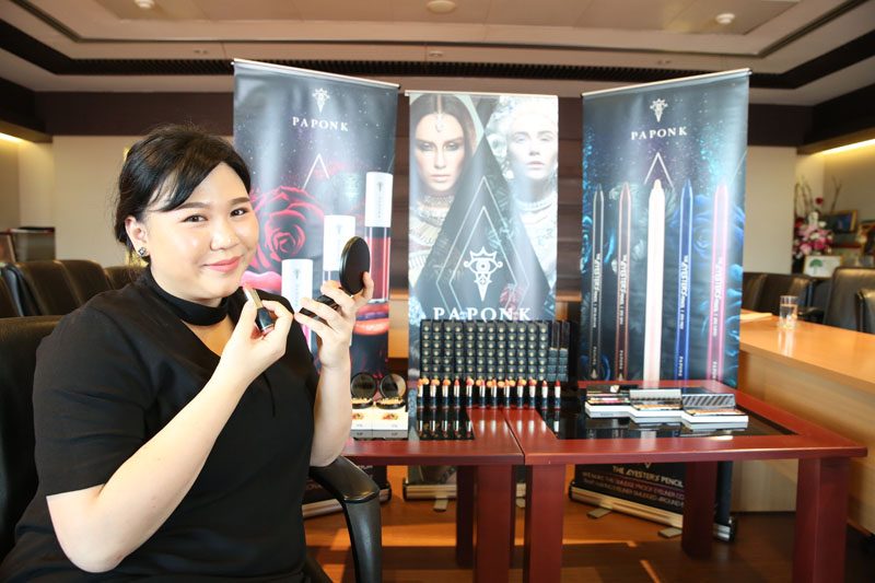 Paponk founder Arpaporn Leuchaputiporn applies Hero from her Poet Soothing Lip Color lineup.