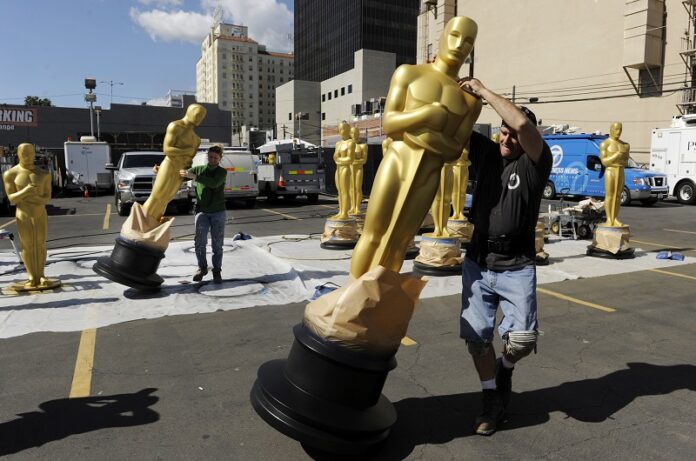 Scenic artists move Oscar statues out of the sun on Wednesday in Los Angeles. The 89th Academy Awards will be held on Sunday. Photo: Chris Pizzello / Invision / Associated Press