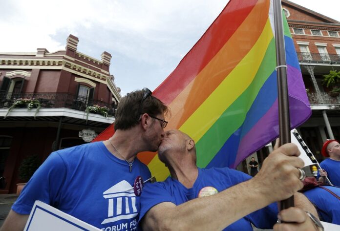 John Hill, chairman of the Forum For Equality in Louisiana, right, kisses his partner, John Weimer, Jr., at a celebration rally IN 2013 in Jackson Square in New Orleans. Photo: Gerald Herbert / Associated Press