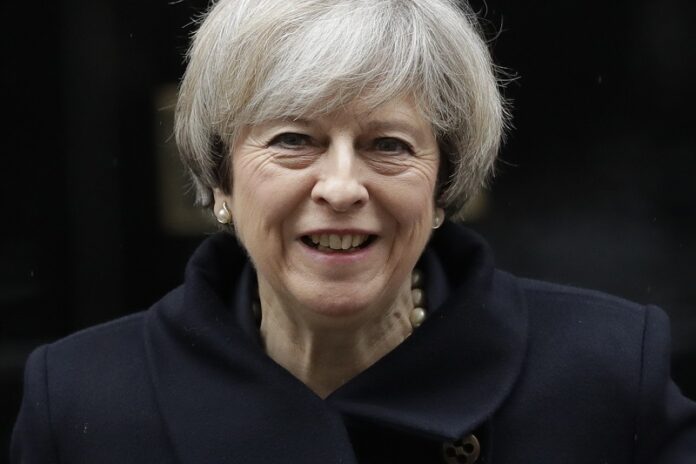 British Prime Minister Theresa May leaves 10 Downing Street in London, to attend Prime Minister's Questions in 2017 at the Houses of Parliament. Photo: Matt Dunham / Associated Press