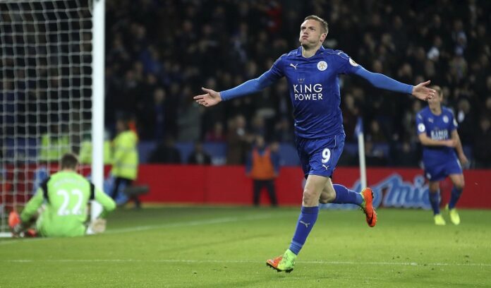 Leicester City's Jamie Vardy, left, celebrates scoring his side's third goal goal during the English Premier League soccer match between Leicester and Liverpool, Monday at the King Power Stadium, in Leicester, England. Photo: Nick Potts / Associated Press