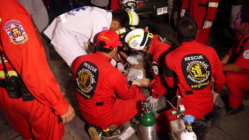 First responders treat Nawapol Puengpai, 17, on a Chonburi city road before taking him to a hospital where he died Saturday evening.