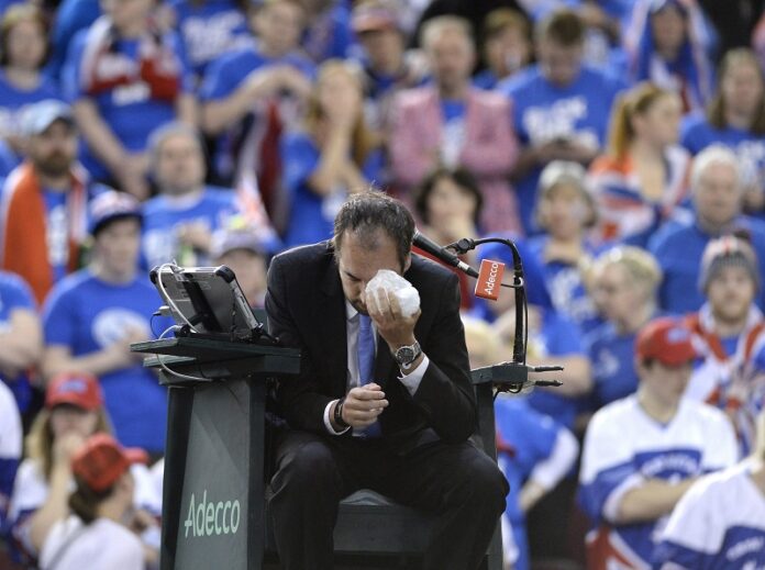 Umpire Arnaud Gabas, of France, holds ice to his face after being hit in the eye by a ball during a Davis Cup tennis mach between Canada's Denis Shapovalov and Britain's Kyle Edmund Sunday in Ottawa, Ontario. Photo: Justin Tang / Associated Press