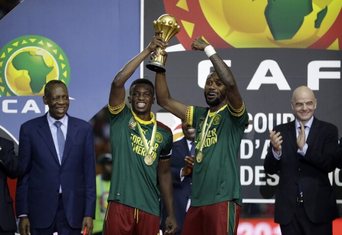 Cameroon's Benjamin Moukandjo, left, and Nicolas Nkoulou lift the trophy after winning the African Cup of Nations final soccer match between Egypt and Cameroon Sunday at the Stade de l'Amitie, in Libreville, Gabon. Photo: Sunday Alamba / Associated Press