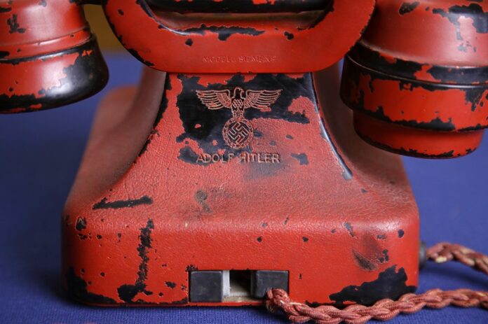 An engraving of a swastika and Adolf Hitler's name are seen on the back of Hitler's personal traveling telephone Friday at Alexander Historical Auctions in Chesapeake City. Photo: Patrick Semansky / Associated Press