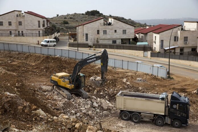 Heavy machinery work at a construction site last month in the West Bank Jewish settlement of Ariel. Photo: Ariel Schalit / Associated Press