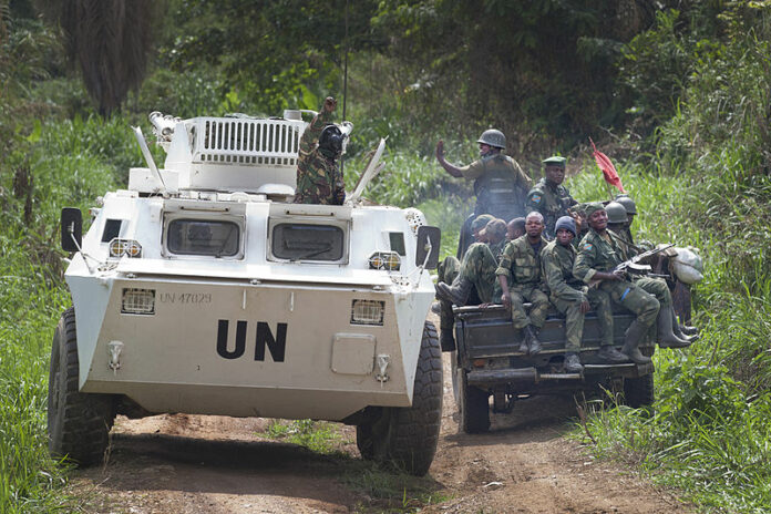 A MONUSCO APC is greeted by FARDC soldiers on their way back from the front line in 2014 in the Beni region where the UN is backing the FARDC in an operation against ADF militia. Photo: MONUSCO Photos / Flickr