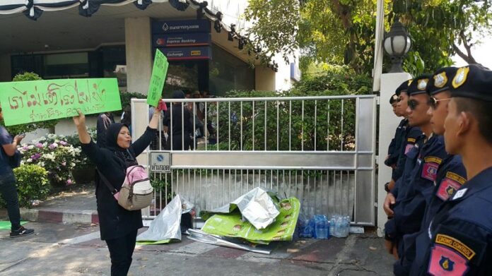 A woman confronts police officers on Saturday at a protest in Bangkok against a government plan to build a coal-fired power plant in Krabi province.