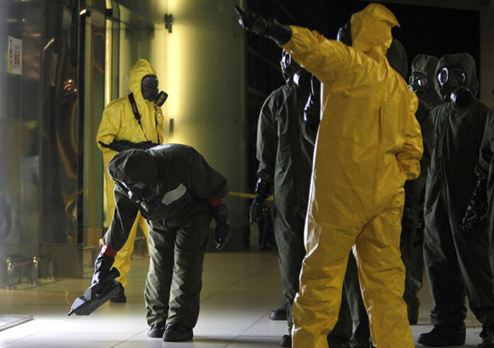 A hazmat crew scans the decontamination zone Sunday at Kuala Lumpur International Airport 2 in Sepang, Malaysia. Photo:Daniel Chan / Associated Press