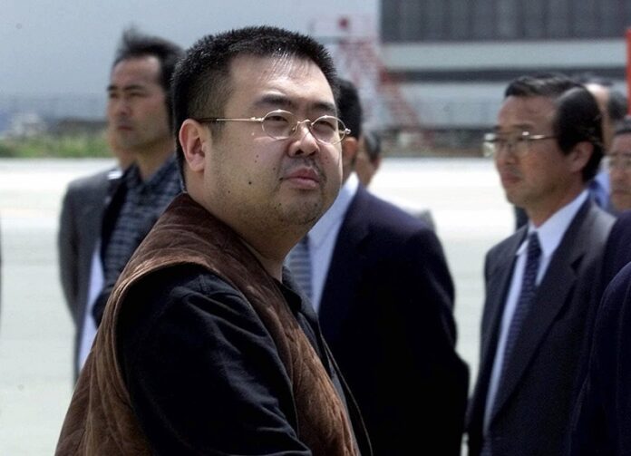 A man believed to be Kim Jong Nam, the eldest son of then North Korean leader Kim Jong Il, looks at a battery of photographers as he exits a police van to board a plane to Beijing at Narita international airport in Narita, northeast of Tokyo, Japan. Photo: Shizuo Kambayashi / Associated Press