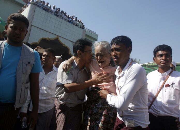 Tin Tin Aye, third from right, mother of Ko Ni who was assassinated by a gunman on Sunday, cries as she attend the funeral Monday at a cemetery in Yangon, Myanmar. Photo: Thein Zaw / Associated Press