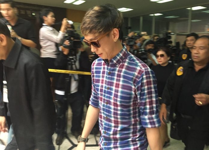 Akarakit ‘Benz’ Worarojcharoendet walks into the Narcotics Suppression Bureau in Bangkok.