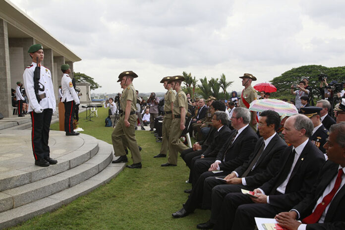 Singapore's National Cadet Corps, at left, and Australian solders participate Wednesday in the Mounting of Catafalque Party at the 75th anniversary of the Fall of Singapore at the Kranji War Cemetery. Photo: David Loh / Associated Press