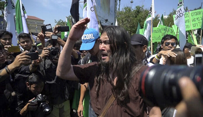 In this image made from video, M.L. Roonguna Kitiyakara, a member of the royal family, yells Friday in protest against a proposed coal-fired plant om Krabi province. Photo: Associated Press