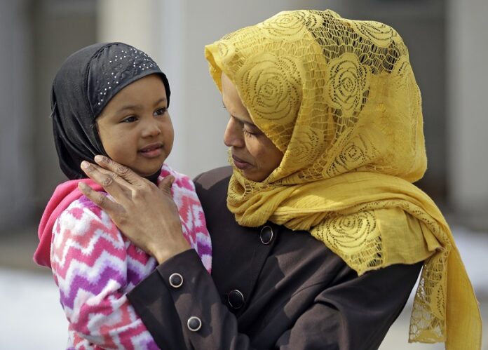 Somali refugee Nimo Hashi holds her daughter Taslim at their home Tuesday in Salt Lake City, Utah. Photo: Rick Bowmer / Associated Press