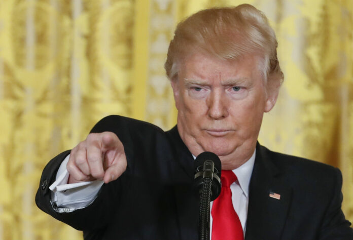 President Donald Trump points to a member of the media as he takes questions during a news conference at the White House in Washington Thursday. Photo: Pablo Martinez Monsivais / AP.