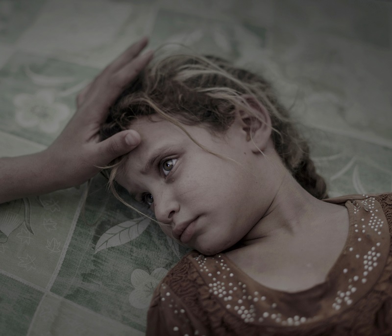 "What ISIS Left Behind" by photographer Magnus Wennman, Aftonbladet, which won first prize in the People, Singles, category of the World Press Photo contest shows five-year-old Maha laying on a dirty mattress in the overcrowded transit center in Debaga refugee camp. Photo: Magnus Wennman / Associated Press