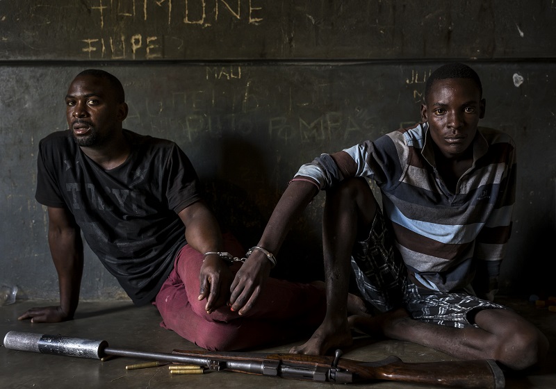 "Rhino Wars" by photographer Brent Stirton, Getty Images for National Geographic Magazine, which won first prize in the Nature, Stories, category of the World Press Photo contest shows Two rhino poachers, one 19, the other 28 years old, apprehended by an anti-poaching team in Mozambique close to Kruger National Park border, South Africa. Photo: Brent Stirton / Associated Press