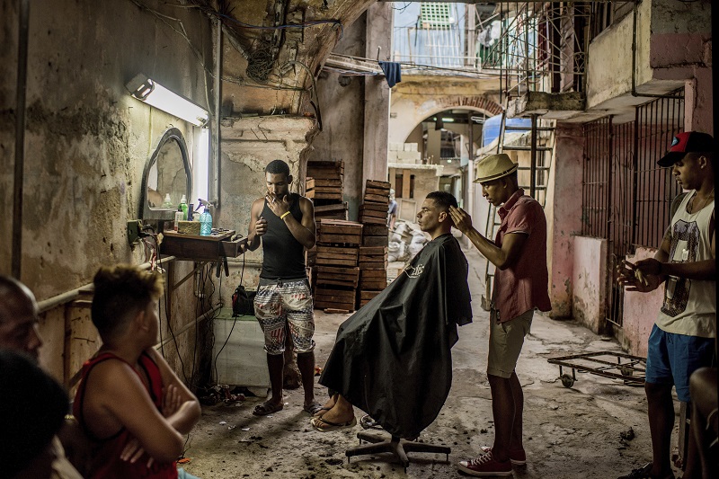 "Cuba On The Edge Of Change" by photographer Tomas Munita for The New York Times, which won first prize in the Daily Life, Stories, category of the World Press Photo contest shows a weathered barber shop in Old Havana, Cuba. Photo: Tomas Munita / Associated Press