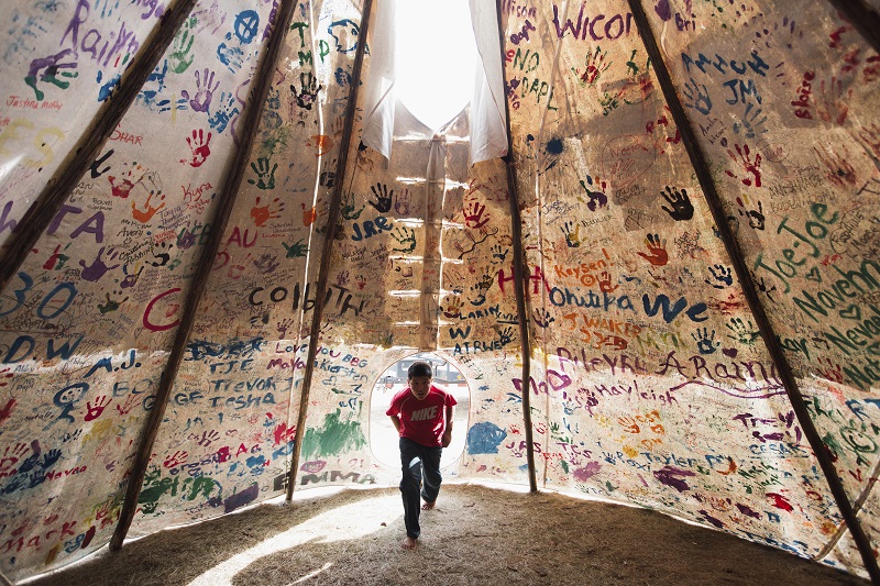 "Standing Rock" by photographer Amber Bracken which won first prize in the Contemporary Issues, Stories, category of the World Press Photo contest shows Jesse Jaso, 12, as he enters the Unity Teepee, at the Sacred Stone Camp. Photo: Amber Bracken / Associated Press