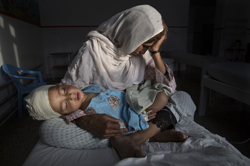 "The Silent Victims Of A Forgotten War" by photographer Paula Bronstein for Time Lightbox / Pulitzer Center For Crisis Reporting, which won first prize in the Daily Life, Singles, category of the World Press Photo contest shows Najiba at the hospital holding her two-year-old nephew Shabir who was injured from a bomb blast in Kabul, Afghanistan. Paula Bronstein / Associated Press