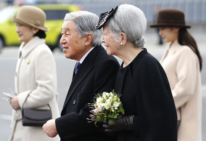Japan's Emperor Akihito and Empress Michiko walk to boarding a plane to leave for Vietnam on Tuesday at the Haneda International Airport in Tokyo. Photo: Shizuo Kambayashi / Associated Press