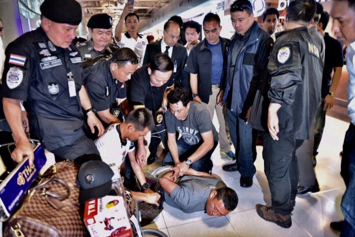 Police on Jan. 19 arrest alleged Laotian druglord Xayasana Keopimpha shortly after landing at Suvarnabhumi Airport