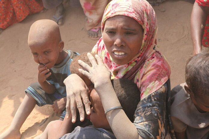 A woman with her children seen here in 2011 in Dadaab refugee camp, Kenya. Photo: Oxfam East Africa / Wikimedia Commons