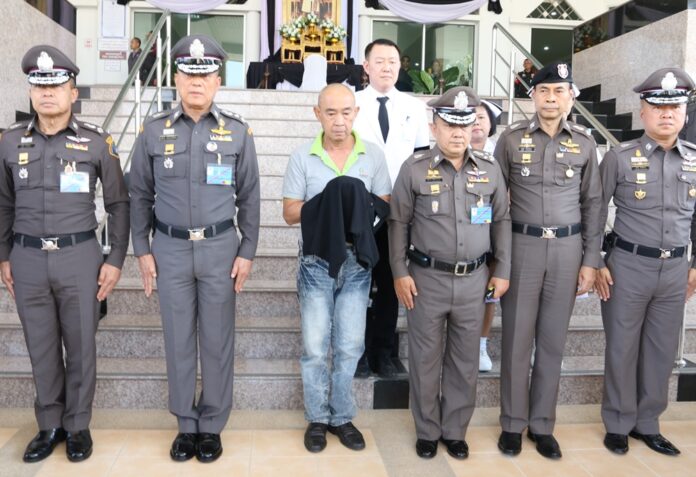 Former palace official and police commander Jumpol Manmai is brought to Nakhon Ratchasima provincial court Thursday for his remand hearing. At the height of his police career, Jumpol outranked nearly every officer in this picture.