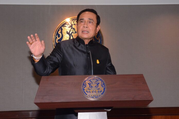 Junta chairman Prayuth Chan-ocha speaks at Government House on Tuesday.