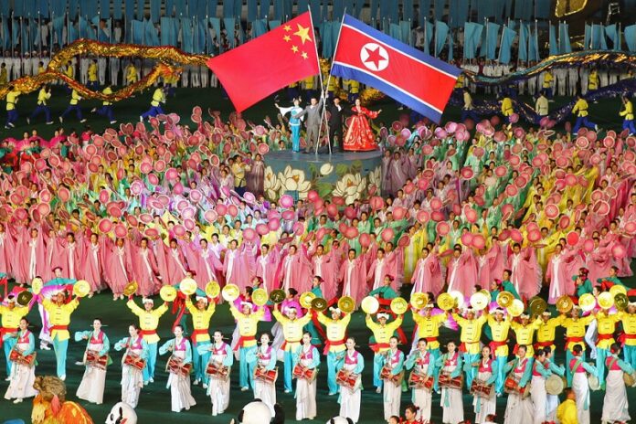 A parade displaying a North Korean and a Chinese flag in 2010 in Pyongyang, North Korea. Photo: Roman Harak / Flickr